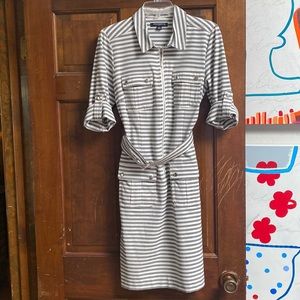 Stretch tailored shirt dress in crisp stripes. Mid knee length, self belt.
